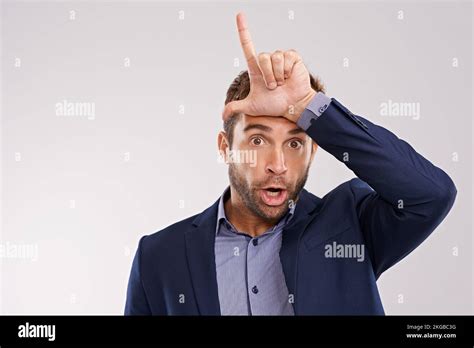 Loser. Portrait of a man making a loser gesture with his hand Stock Photo - Alamy