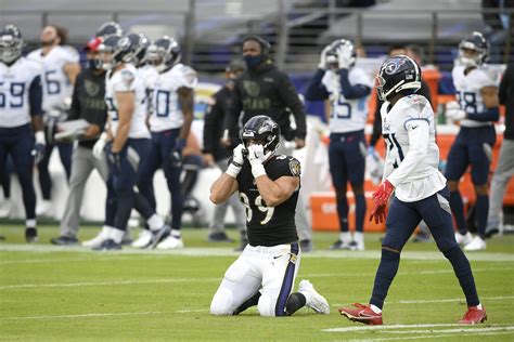 Ravens dip into 3rd place after fading in OT loss to Titans | AP News