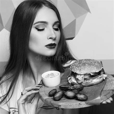 Female Model Demonstrating Burger Lying on Round Wooden Plate Stock Image - Image of face ...