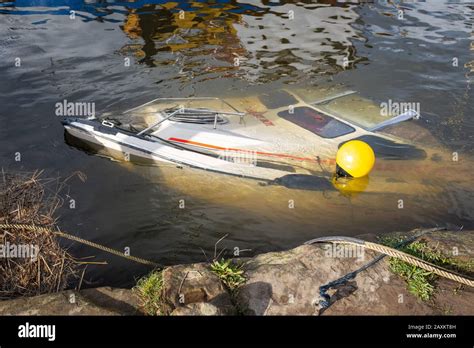 Small sunken boat at Kingholm Quay harbour, Scotland. Possibly due to flooding in the aftermath ...