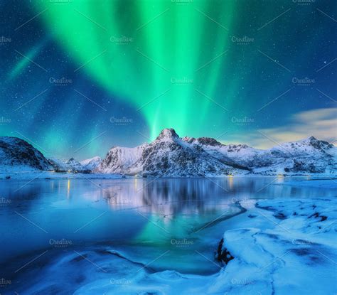 Aurora borealis over snowy mountains containing aurora, northern lights ...