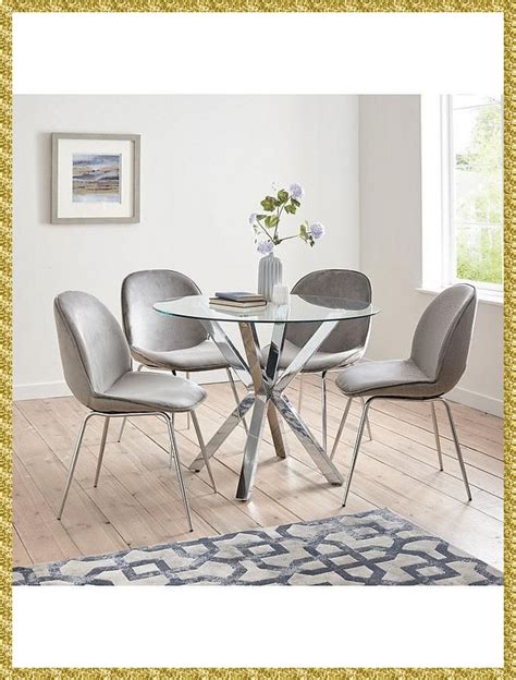 a glass table with four chairs around it