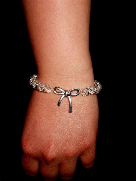 Clear glass bead strechy bracelet with silver tone bowknot charm | Jewelry, My jewellery ...