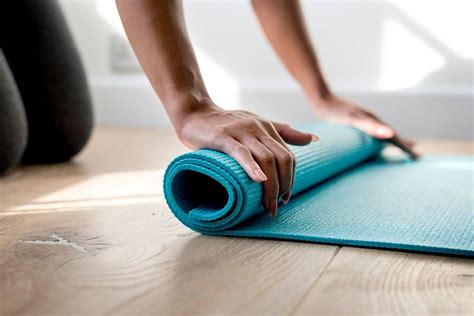 Woman rolling yoga mat | Premium Photo - rawpixel