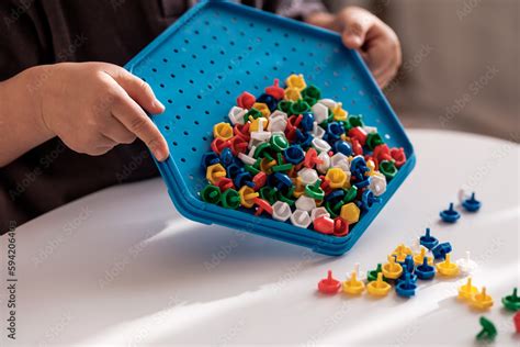 Little child playing peg board mosaic toy, sensory activities for toddlers Stock Photo | Adobe Stock