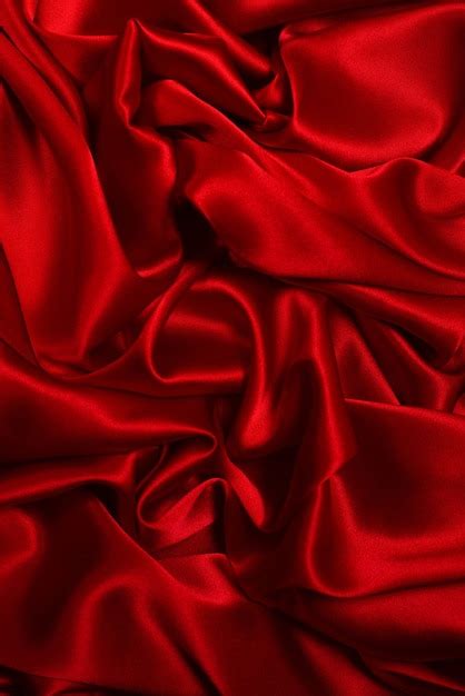 Premium Photo | Rich and luxury red silk fabric texture background. Top view.