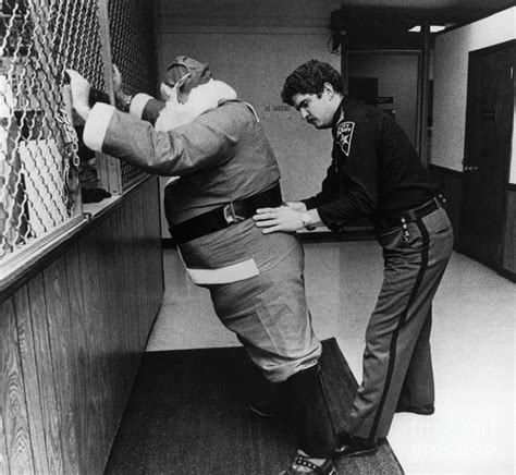 Sheriff Frisking Santa Claus by Bettmann