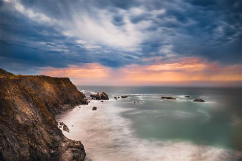 Cliffside view of the stormy Northern California Coast at sunset ...