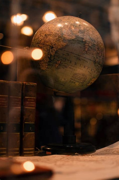 Old books and globe in library · Free Stock Photo