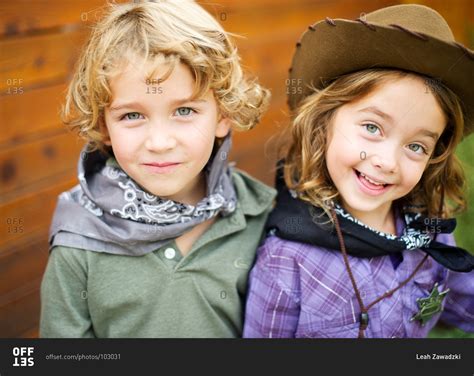 Portrait of fraternal twins in western costume stock photo - OFFSET