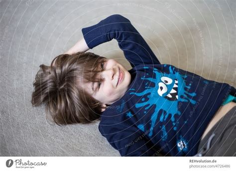 happy child lying on the floor - a Royalty Free Stock Photo from Photocase