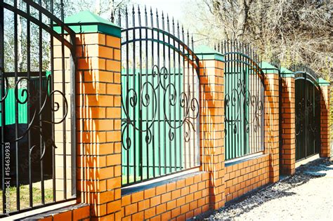 Brick and Metal Fence with Door and Gate of Modern Style Design Metal Fence Ideas. Stock Photo ...