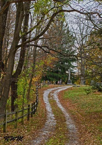 a dirt road in the middle of a cemetery