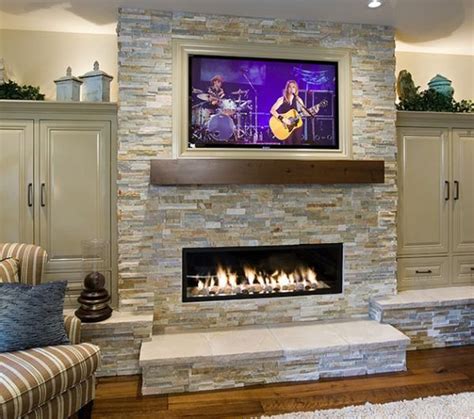 stone fireplace designs with tv above - Carlotta Bannister