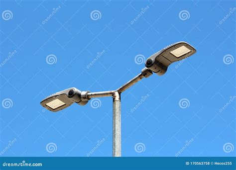 Dual Modern LED Street Lights with Adjustable Angle Mounted on Single Tall Metal Pole Stock ...