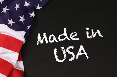 Hands holding board with Made in USA text with USA flag background ...