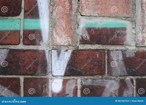 Brick wall with graffiti stock photo. Image of cracked - 86106154