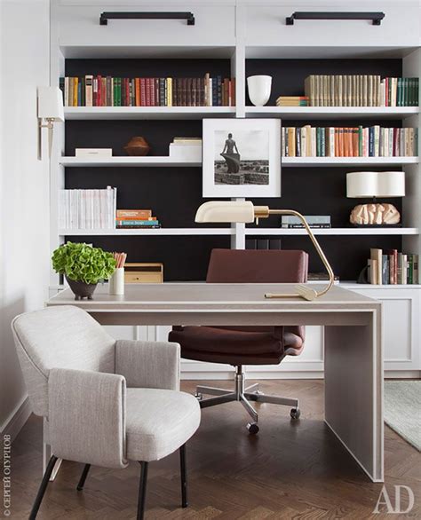 an office with a desk, chair and bookshelf in the back ground area