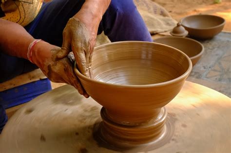 Premium Photo | Pottery - skilled wet hands of potter shaping the clay ...