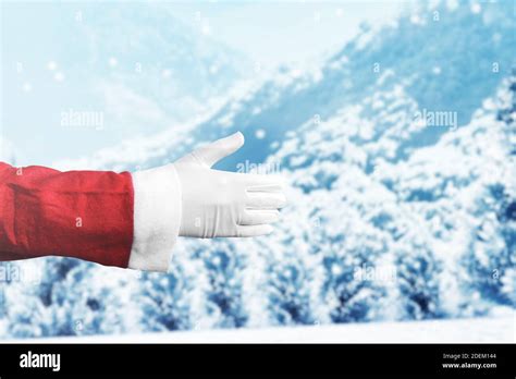 Santa Claus hand offer to shaking hands with snowfall background Stock Photo - Alamy