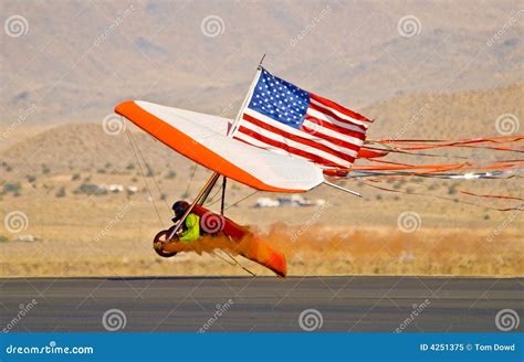 Hang glider landing stock image. Image of hang, land, orange - 4251375