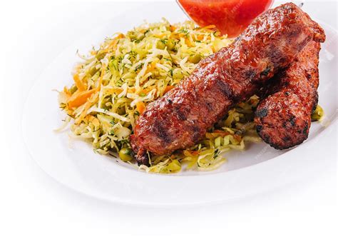 Premium Photo | Moldavian traditional mititei mici meat sticks with cabbage and a sauce