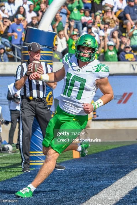 Oregon Ducks quarterback Bo Nix runs through the endzone after... News ...