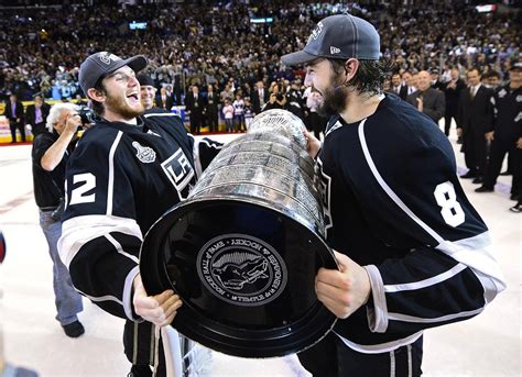 Download Drew Doughty Holding The Stanley Cup With Team Player Jonathan ...