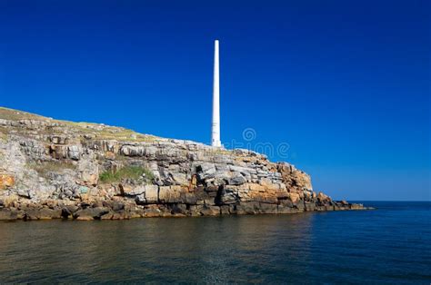 The Lighthouse On The Rocky Shore Of Snake Island Stock Photo - Image: 25945548