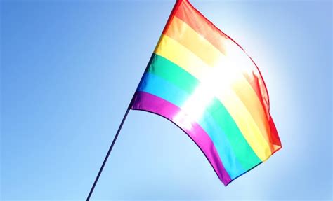 Premium Photo | Gay flag on blue sky background