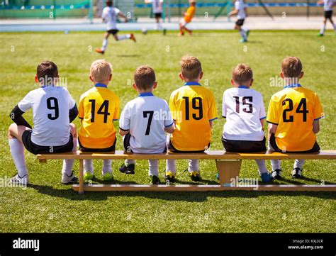 Football players sitting on bench hi-res stock photography and images - Alamy