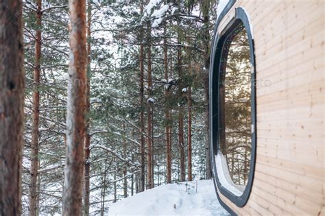 Wooden tiny house snowy winter forest. Glamping Stock Photo by smlub