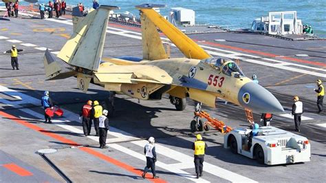 China's Shenyang J-15 naval jet fighter carrying out its first successful landing and takeoff on ...