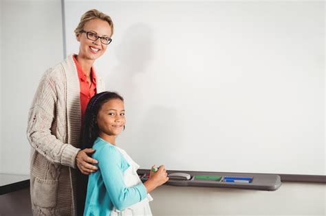 Premium Photo | Teacher and pupil standing in front of whiteboard