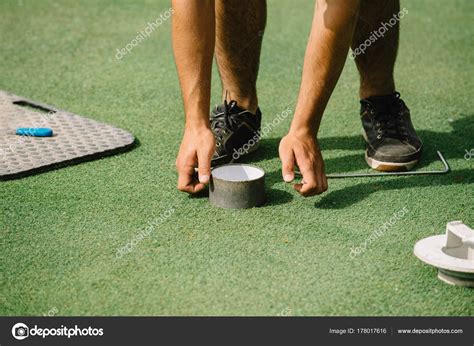 Golf Course Maintenance Greenskeeper Cutting Golf Hole Stock Photo by ©microgen 178017616