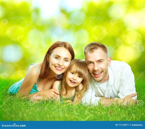 Happy Smiling Young Family Outdoors Stock Image - Image of lying, love ...