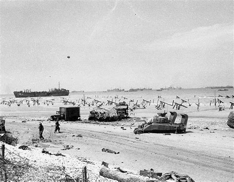 Scene on Omaha Beach on the afternoon of 6 June 1944, showing casualties on the beach, a bogged ...