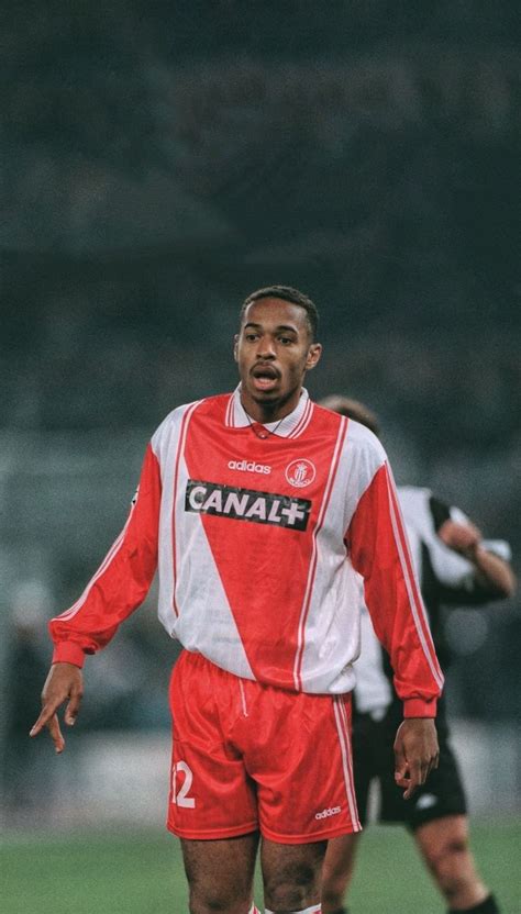 a man standing on top of a soccer field wearing a red and white uniform with the word canaan ...