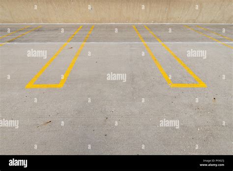 Empty parking spaces with yellow lines in a parking garage Stock Photo ...