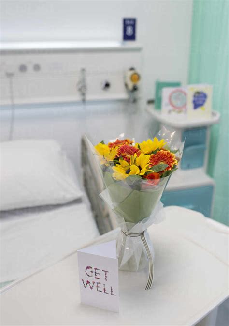 Flower bouquet and Get Well card on tray in vacant hospital room stock ...