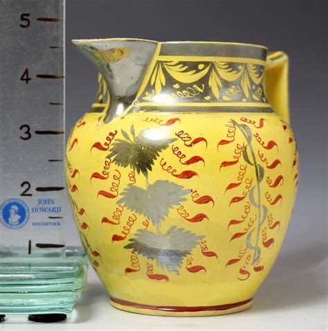 English pottery antique pitcher with canary yellow ground and silver ...