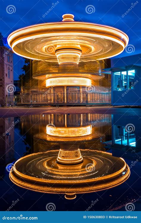 Merry Go Round at Night in Amusement Park with Reflection. Stock Image - Image of modern ...