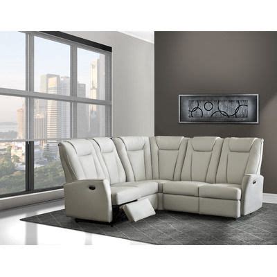 a white leather sectional sofa in front of a large window