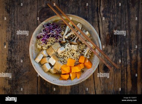 Miso Ramen soup with noodles, red radish sprouts, pumpkin, fried tofu ...