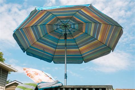 "Blue Patio Umbrella" by Stocksy Contributor "Jen Grantham" - Stocksy