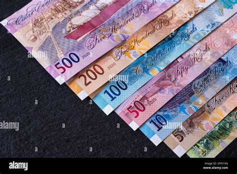 New Qatari Riyal banknotes on black background Stock Photo - Alamy