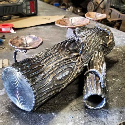 Just finished this steel log candle holder. The mushrooms are copper ...