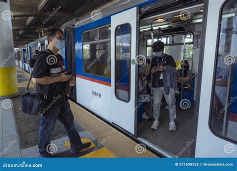 Pasig, Metro Manila, Philippines - a Man Enters the Passenger Car of the MRT Line 3 Light Rail ...