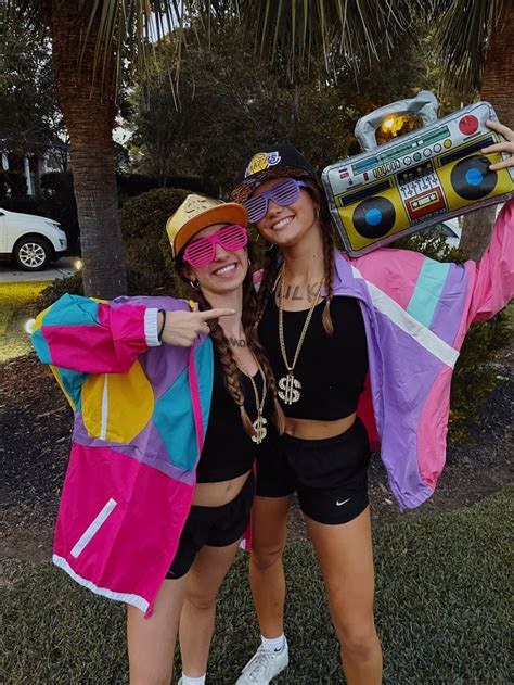 two women dressed up in costumes posing for the camera