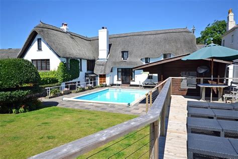 This picture perfect thatched cottage boasts a superb outdoor swimming pool, sauna and pool ...